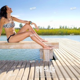 Young girl relaxed with bikini at lake in summertime