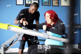 Disabled woman doing physical therapy with trainer