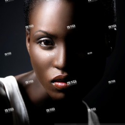 Young black african woman artistic closeup face beauty portrait with dramatic lighting
